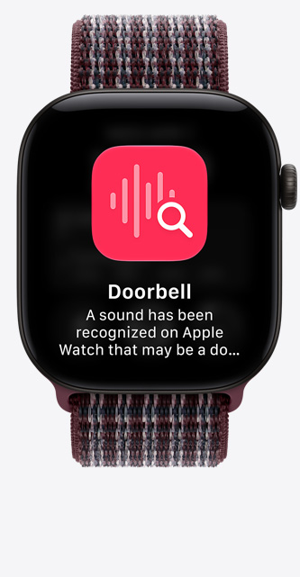 Apple Watch Series 12, screen shows sound recognition of doorbell, aluminum case, black color, connected to Sport Loop band, burgundy plaid color